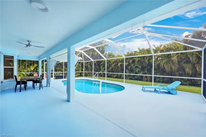 Swimming pool with a sunroom, a lanai, and a patio area