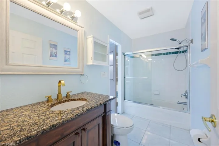Full bathroom with vanity and combined bath / shower with glass door