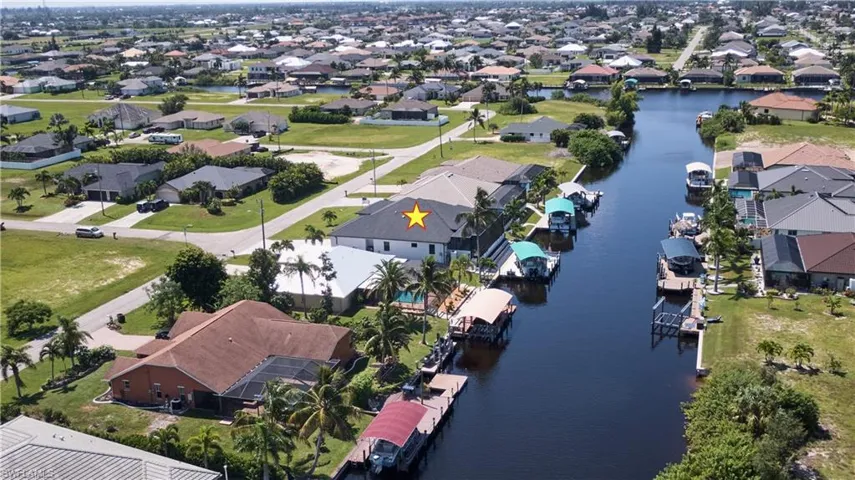 Birds eye view of property with a water view