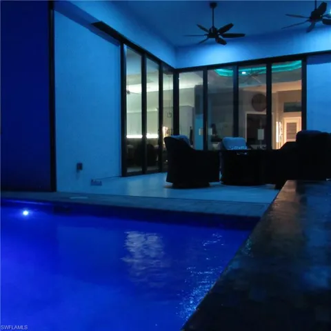 View of pool with ceiling fan