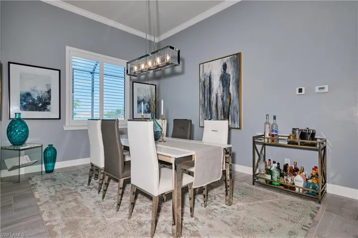 Dining room with crown molding, a chandelier, and hardwood / wood-style flooring