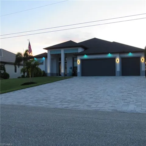 Prairie-style house featuring a garage and a yard