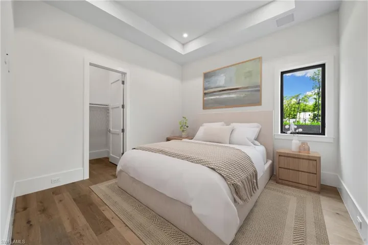 Bedroom featuring hardwood / wood-style flooring, a walk in closet, and a closet