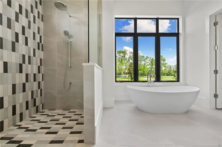Bathroom featuring tile patterned flooring and independent shower and bath