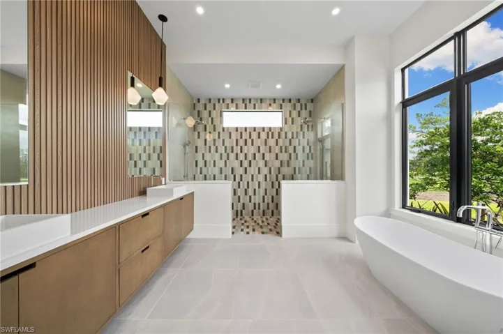 Bathroom featuring vanity, independent shower and bath, and tile patterned floors