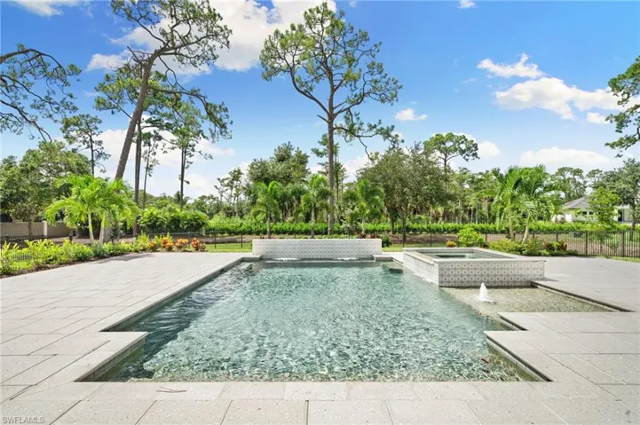 View of swimming pool featuring an in ground hot tub, pool water feature, and a patio area