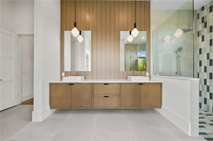Bathroom featuring vanity and an enclosed shower