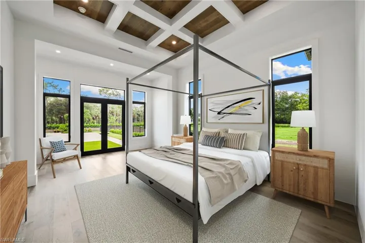Bedroom with coffered ceiling, wood-type flooring, beamed ceiling, and french doors