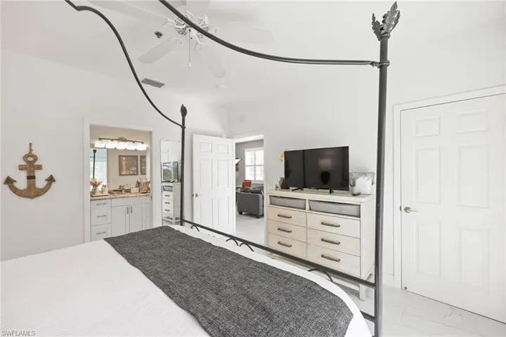 Bedroom with ensuite bath and ceiling fan