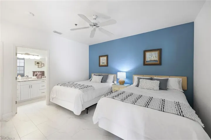 Bedroom featuring ceiling fan and ensuite bath
