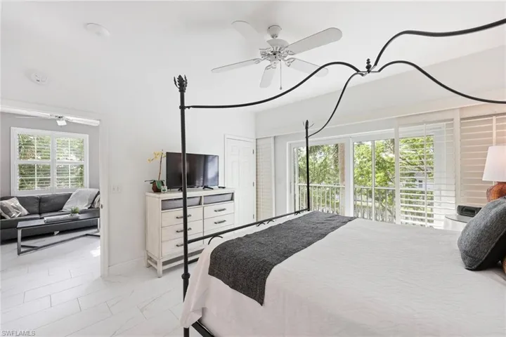 Bedroom featuring multiple windows and ceiling fan