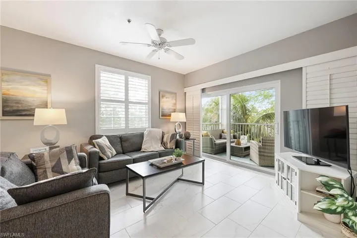 Living room featuring ceiling fan and a healthy amount of sunlight