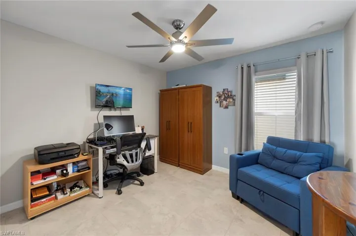 Office space/4th bed featuring ceiling fan