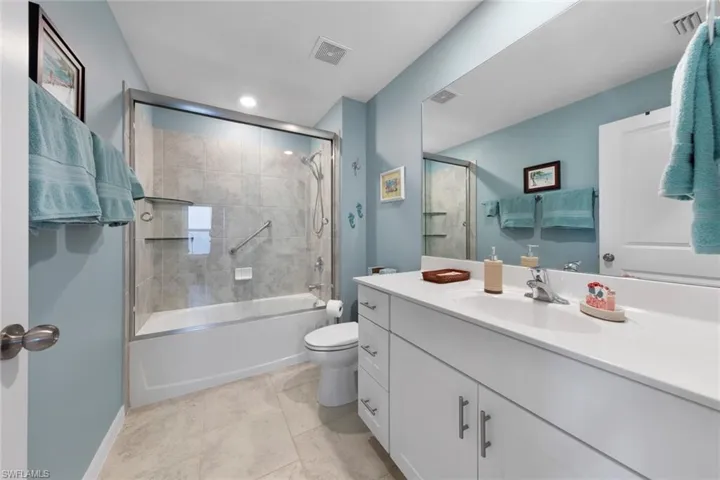 Full bathroom featuring bath / shower combo with glass door, large vanity