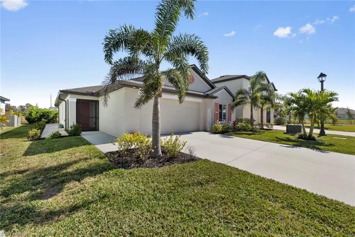 View of front of home featuring a garage and a front lawn