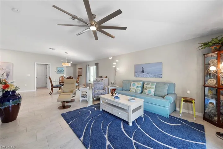 Living room featuring lofted ceiling and ceiling fan