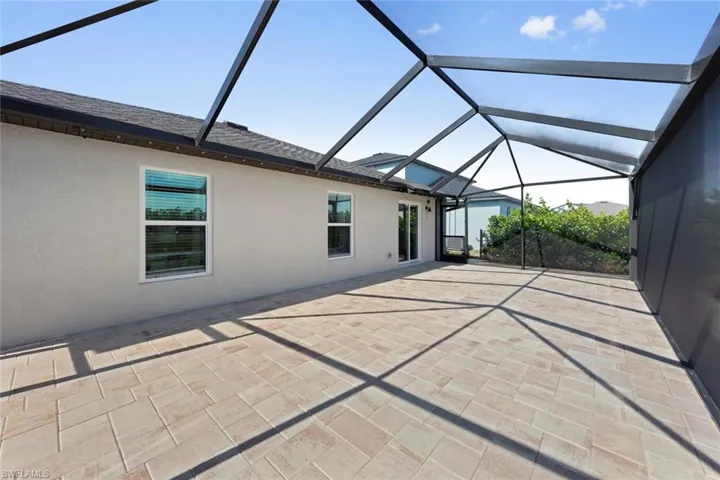 View of patio featuring a lanai