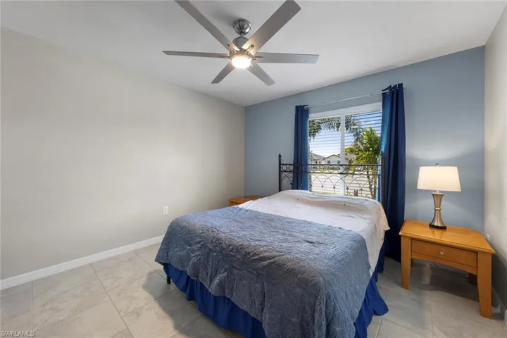 Tiled bedroom with ceiling fan