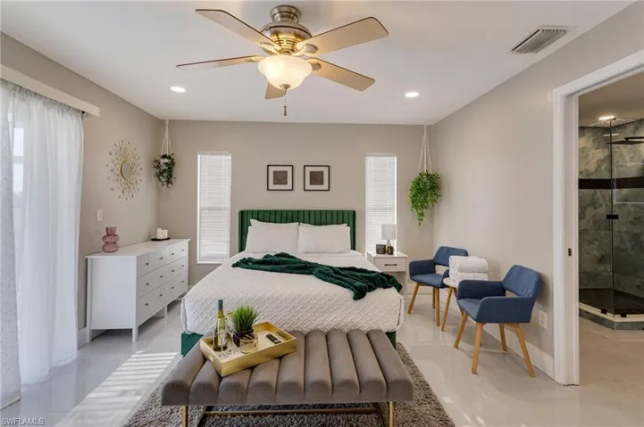 Bedroom with recessed lighting, visible vents, and multiple windows