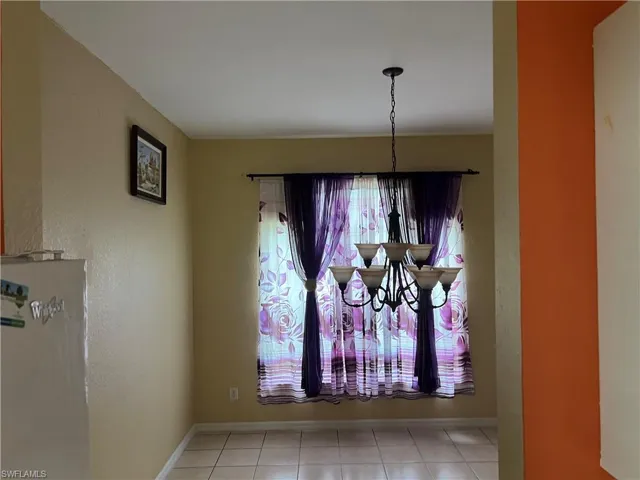 Details featuring a notable chandelier and baseboards