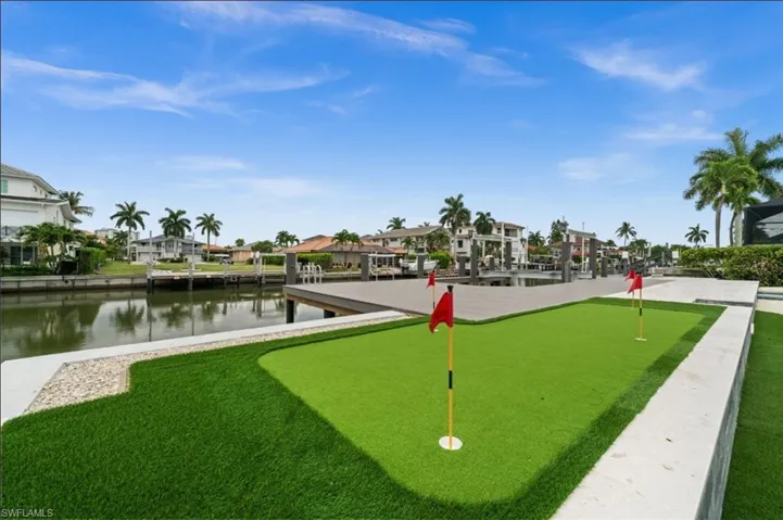 putting green overlooking the gulf access canal and boat dock