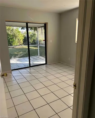 Unfurnished room with light tile patterned flooring