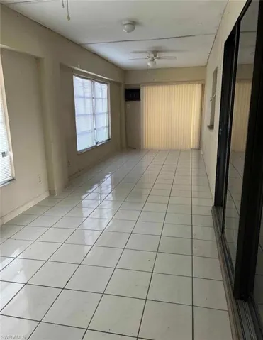 Spare room featuring light tile patterned floors and a ceiling fan