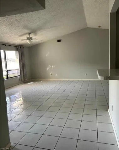 Spare room with light tile patterned floors and a ceiling fan