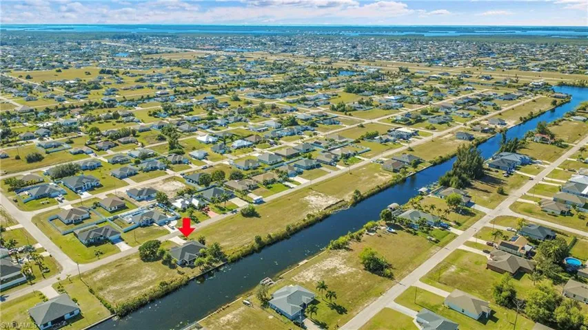 Aerial view of property's location with nearby suburban area and a large body of water