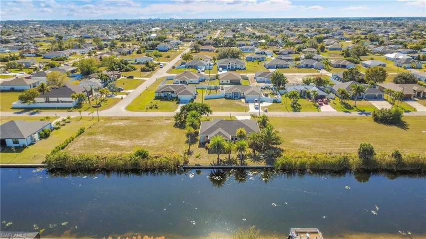 Aerial perspective of suburban area with a large body of water