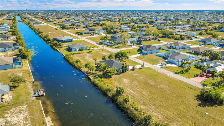 Aerial perspective of suburban area featuring a large body of water