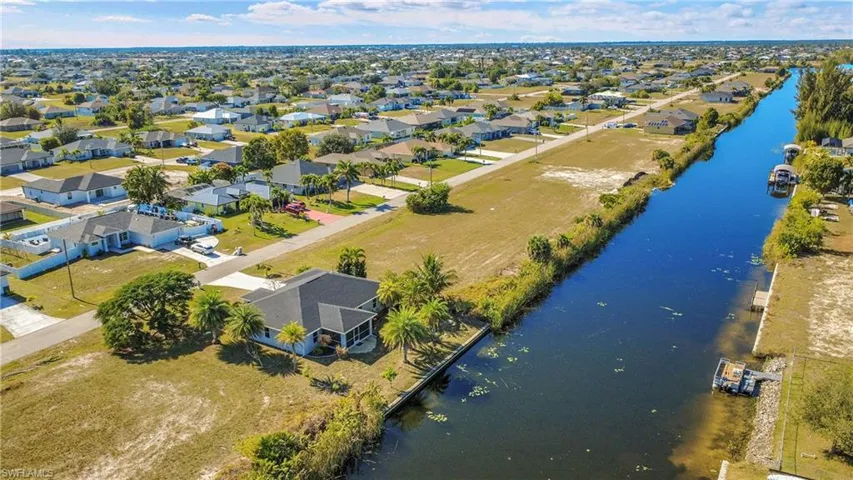 Aerial perspective of suburban area with a nearby body of water