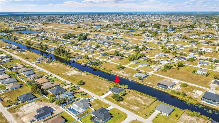 Aerial overview of property's location with nearby suburban area and a large body of water
