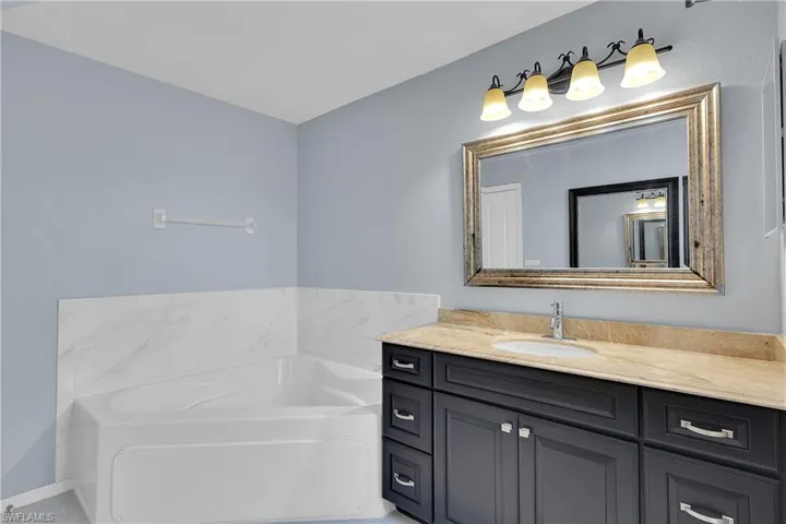 Bathroom featuring a bath and vanity