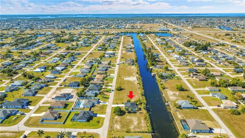 Aerial view of residential area featuring a large body of water