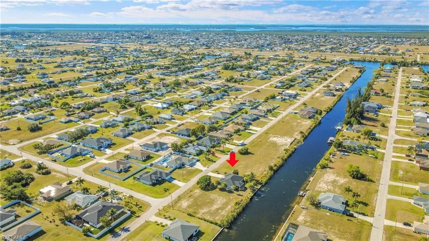 Aerial perspective of suburban area with a large body of water