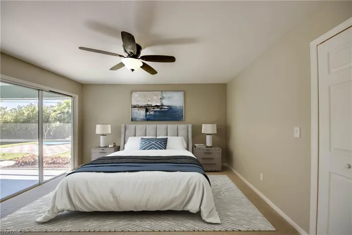 Bedroom with baseboards, carpet floors, access to exterior, and a ceiling fan
