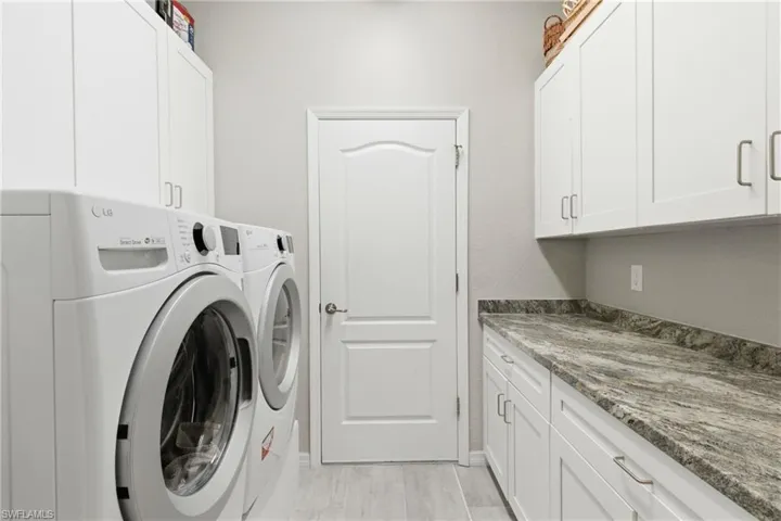 Oversized laundry room with added storage and workspace for everyday convenience.
