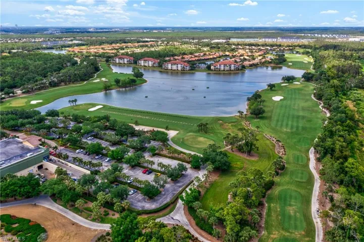 Aerial view of the beautifully maintained golf course in Pelican Preserve showcasing lush fairways and scenic landscaping.