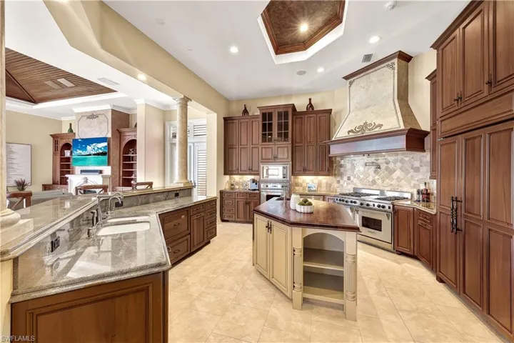 Chef's Kitchen with Custom Cabinetry and woodwork, Wolf Gas range, pot filler, wall ovens, prep sink, SubZero refrigerators, 2 wine refrigerators and endless water views