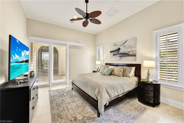 Bedroom with crown molding, ceiling fan, access to outside, and light tile patterned flooring