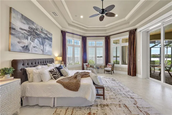 Bedroom with crown molding, multiple windows, access to outside, and ceiling fan