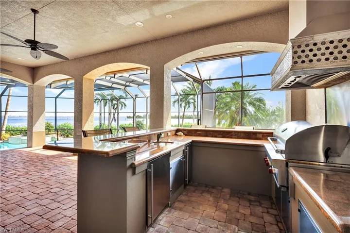 Outdoor Kitchen with gas Grill, bar, hood, icemaker and refrigeration