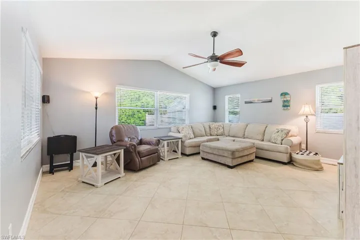 Living area with ceiling fan and light tile patterned floors