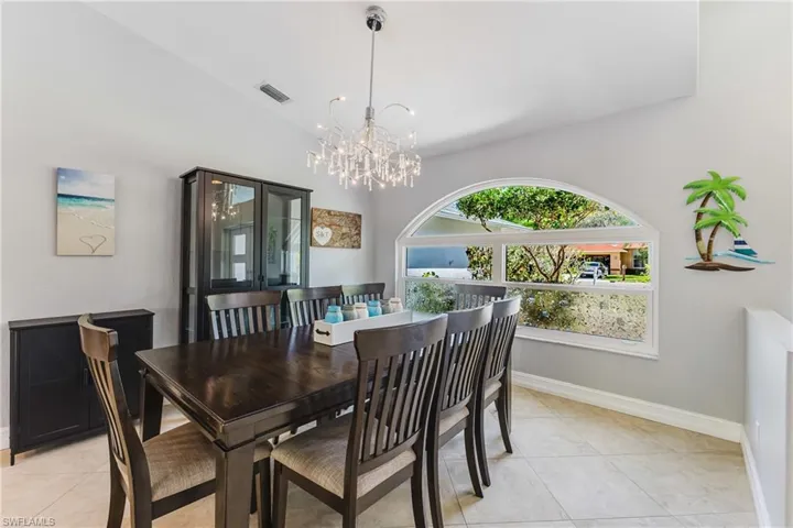Dining room with hanging lights and light tile patterned floors