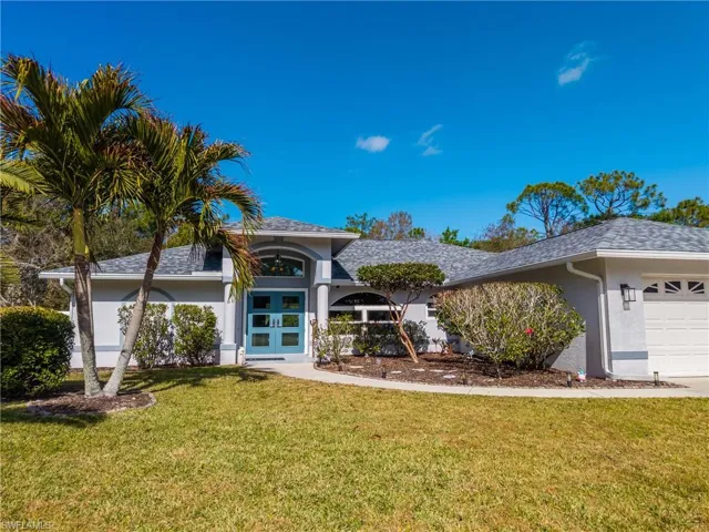 Single story home featuring stucco siding, a front lawn, roof with shingles, and a garage
