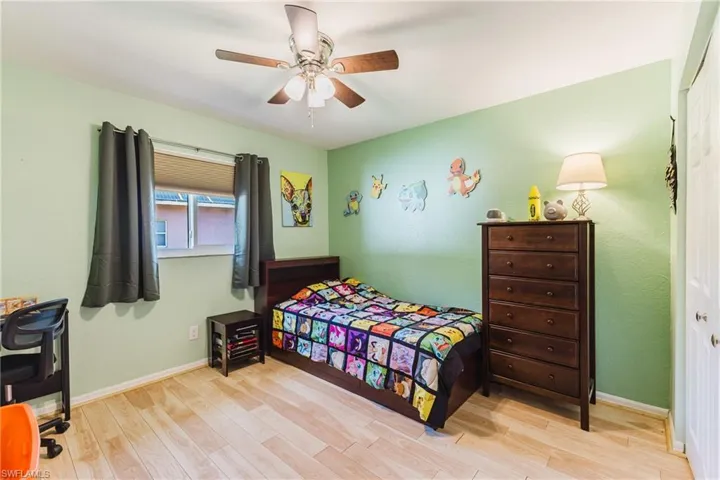 Bedroom featuring light wood-type flooring, a ceiling fan, and a closet