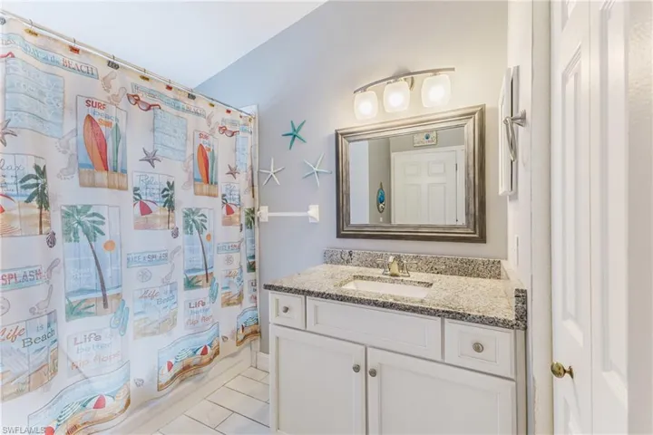 Bathroom with vanity and light tile patterned floors