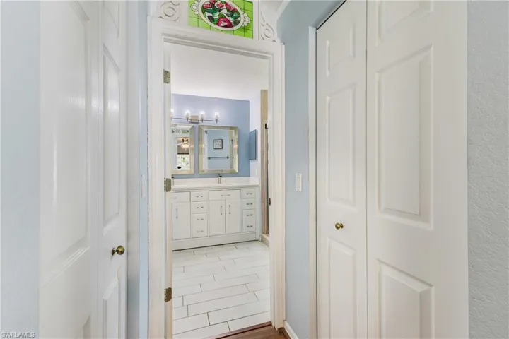 Hallway featuring a sink and wood finished floors