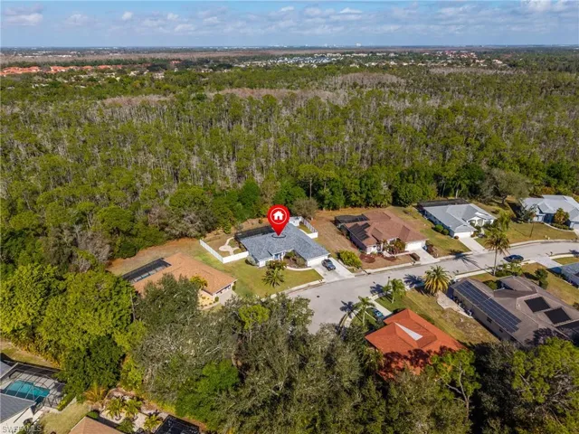 Aerial view of residential area with a heavily wooded area